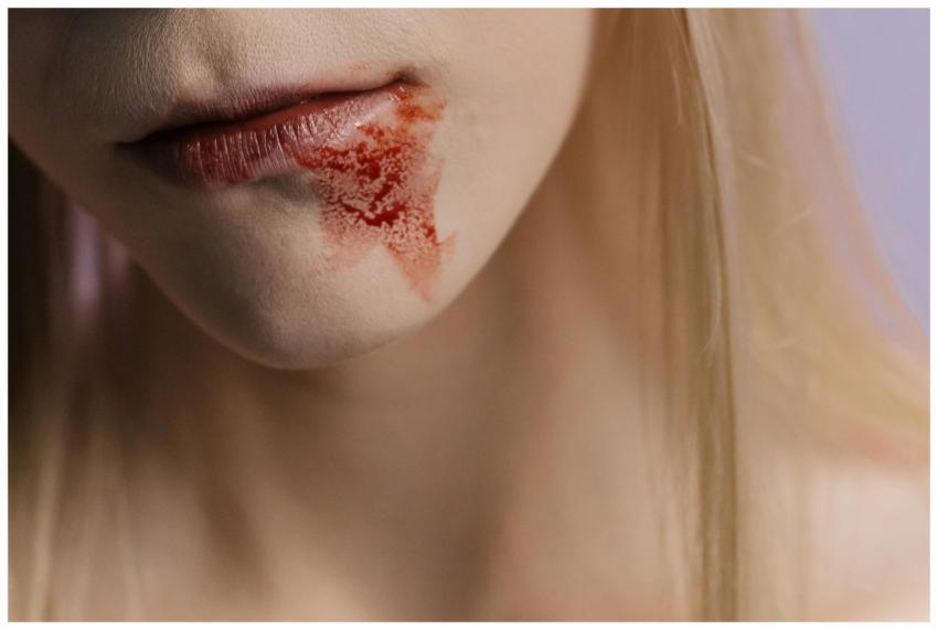 Detailed close-up of lips with a blood stain on th