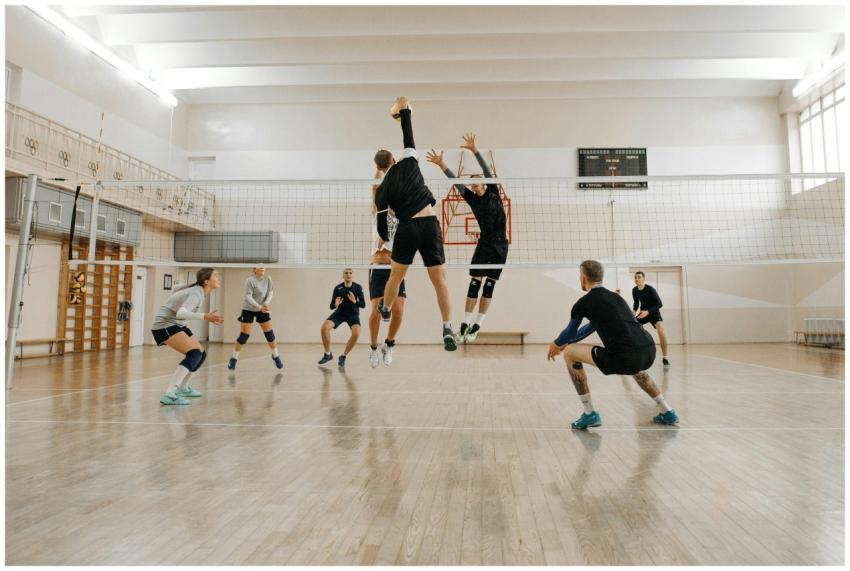 Men and women engaged in a competitive indoor voll