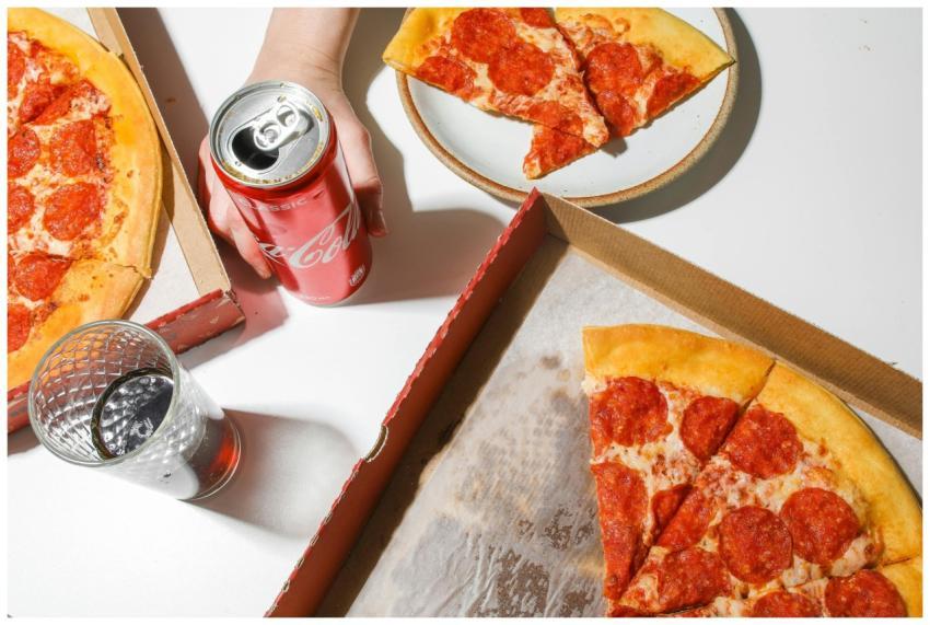 Delicious pepperoni pizza with soda, ideal for fas