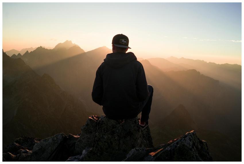 A man sits on a peak in the High Tatras, Slovakia,
