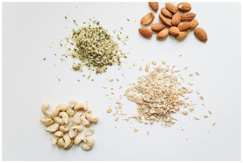 Top view of almonds, cashews, oats, and hemp seeds
