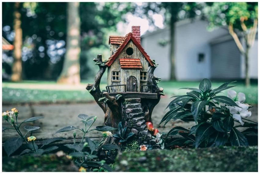 A whimsical miniature house set amidst a lush fair