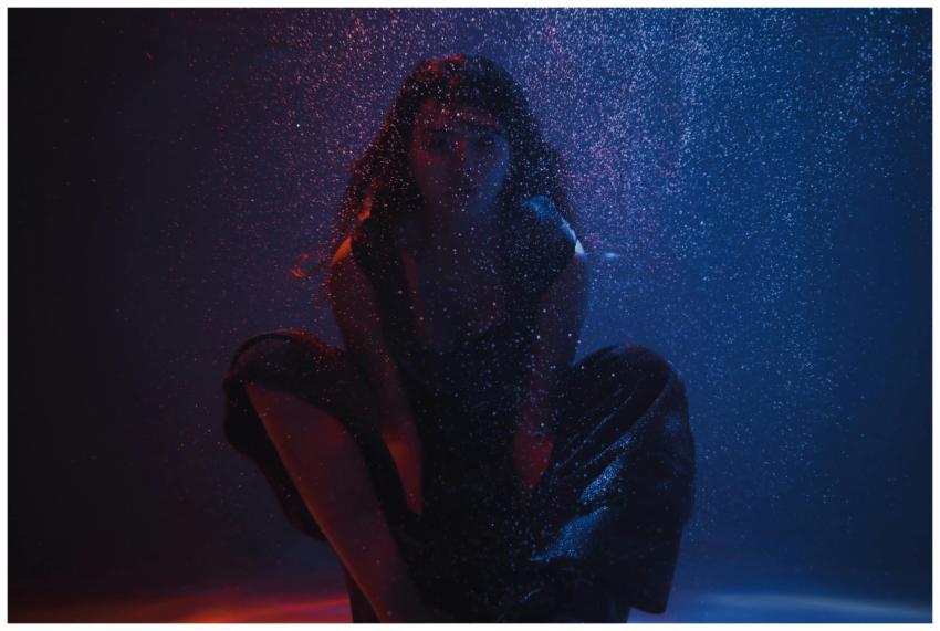 A moody underwater portrait of a woman surrounded