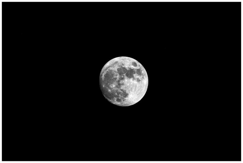 Capture of the full moon set against a pitch black