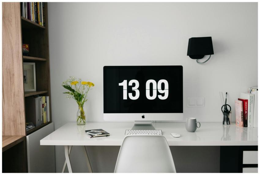 A minimalist workspace featuring a computer displa