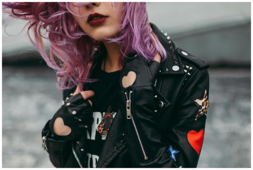 Stylish woman with purple hair in a studded leathe