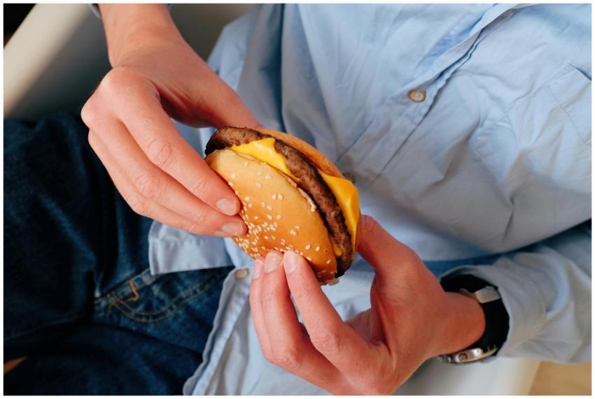 Unrecognizable male in blue shirt sitting on chair