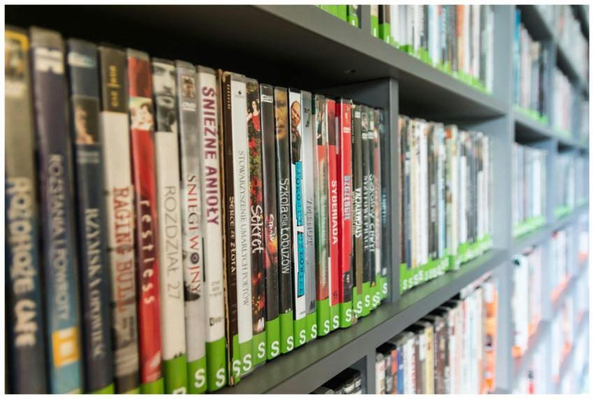 Close-up of a library shelf filled with DVDs showc