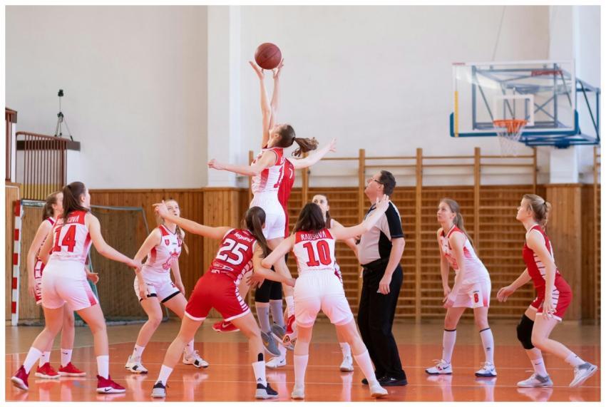 Exciting women's basketball game in a school gym,