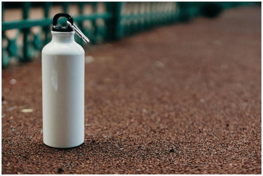 Close-up of a white water bottle with carabiner on