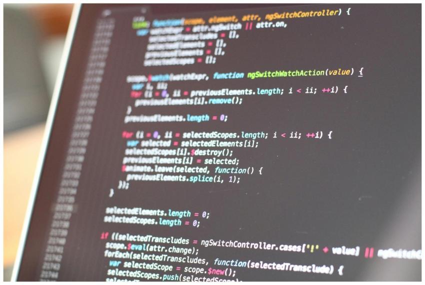 Close-up view of colorful code on a laptop screen,