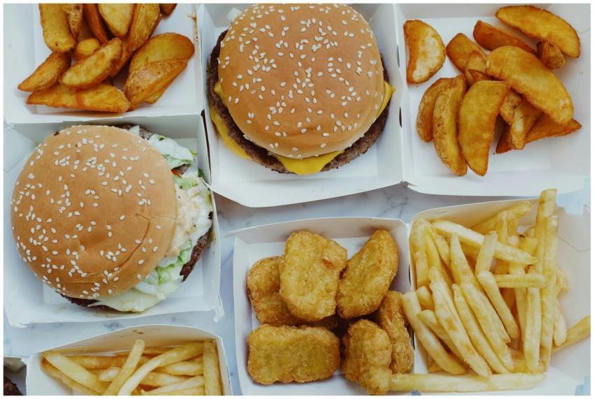 Top view of yummy junk food consisting of burgers