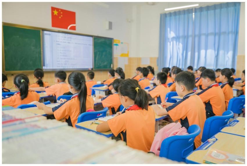 Children attentively listening in a classroom sett