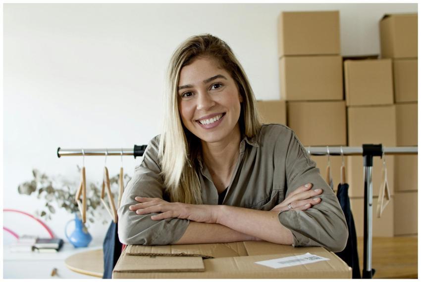 Happy woman managing her online store with package
