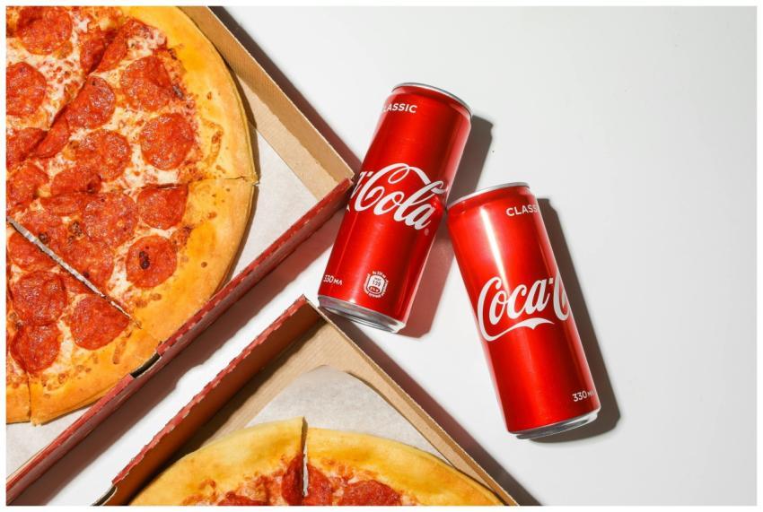 Close-up shot of pepperoni pizza and Coca-Cola can
