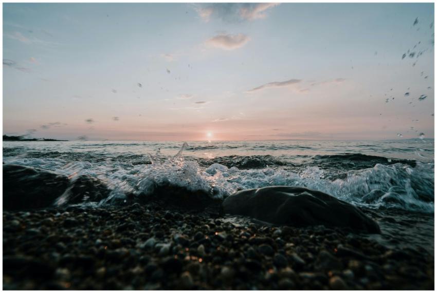 Captivating ocean sunrise with waves crashing on p