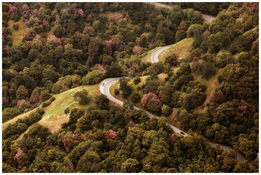 A scenic aerial view of a winding road through a v