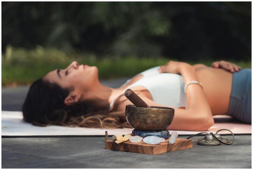 A woman practices relaxation with a singing bowl a