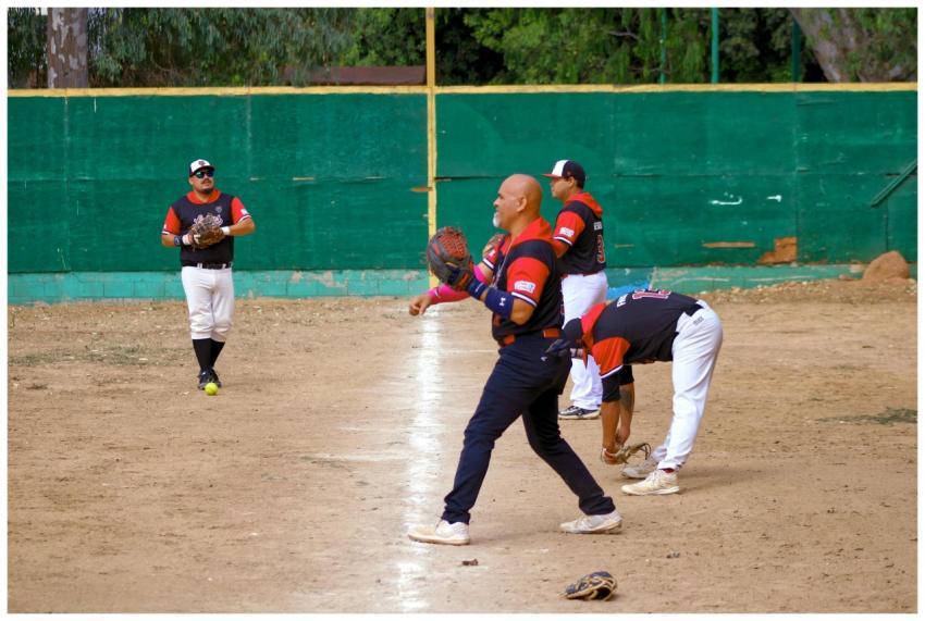 Players engage in an amateur baseball game on a lo