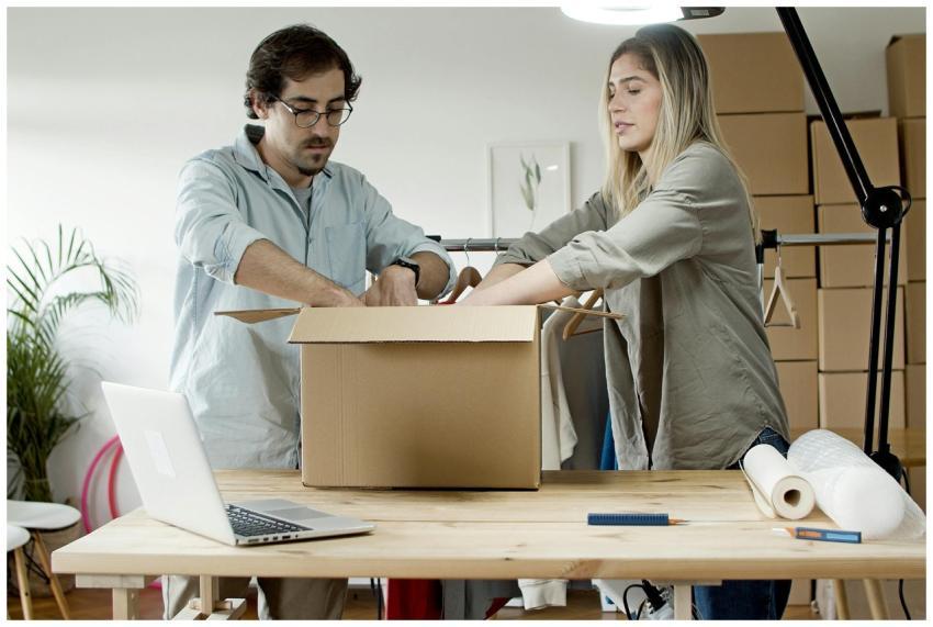 Man and woman packing e-commerce orders at startup