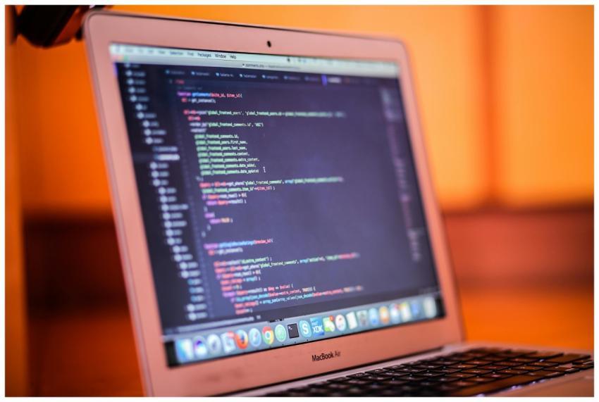 Focused shot of a laptop displaying code, suitable