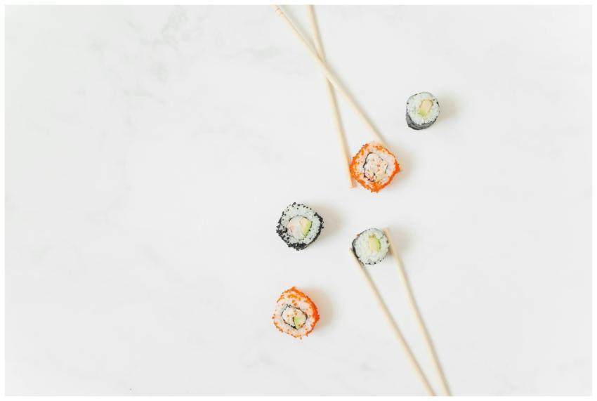 Elegant sushi rolls with chopsticks arranged on a