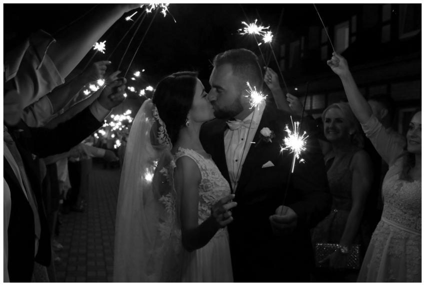 Bride and groom share a romantic kiss with sparkle