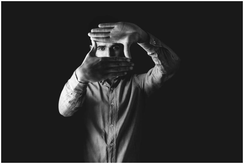 Black and white portrait of a man framing his face