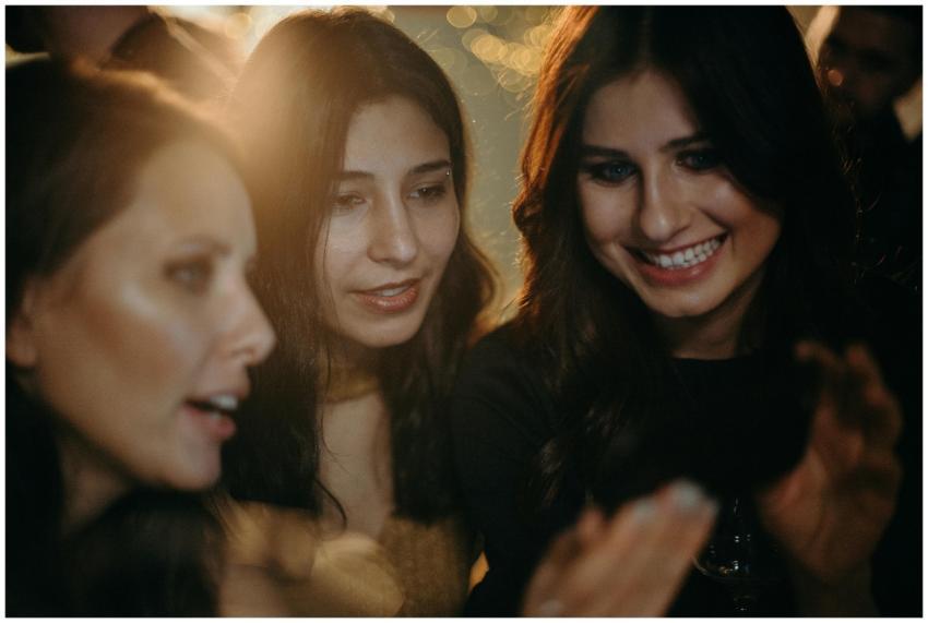 Three young women enjoying a festive night out, ca