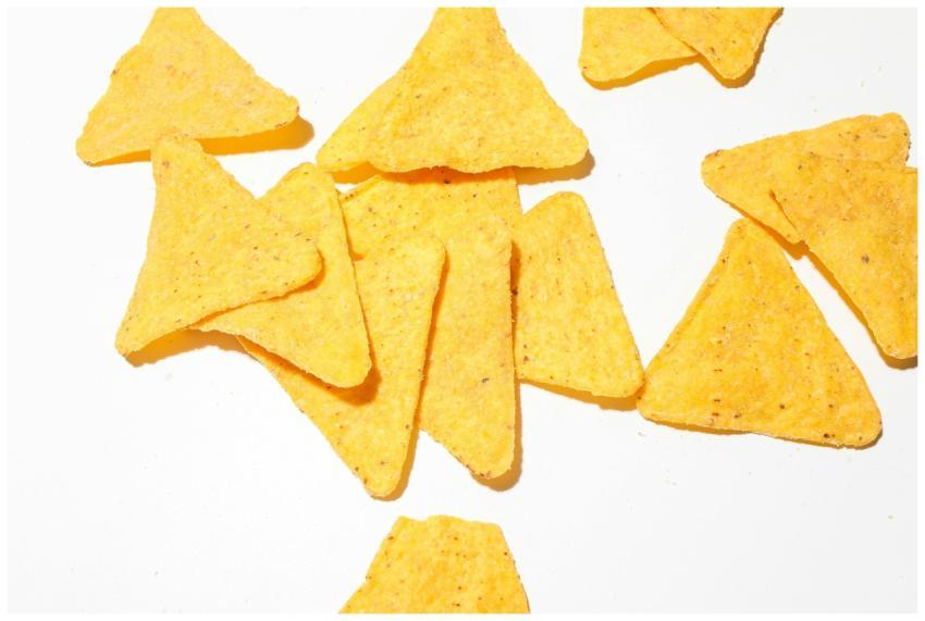 Close-up of crunchy yellow corn tortilla chips sca