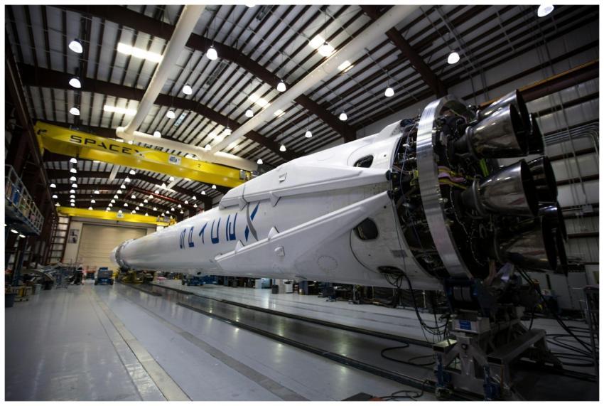 A SpaceX Falcon rocket displayed in a spacious han