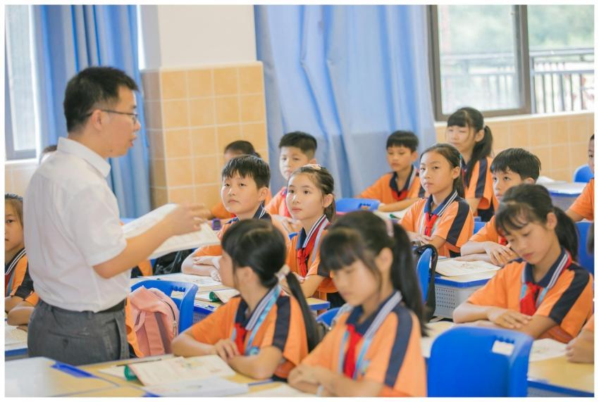 Asian teacher conducting a lesson with attentive s