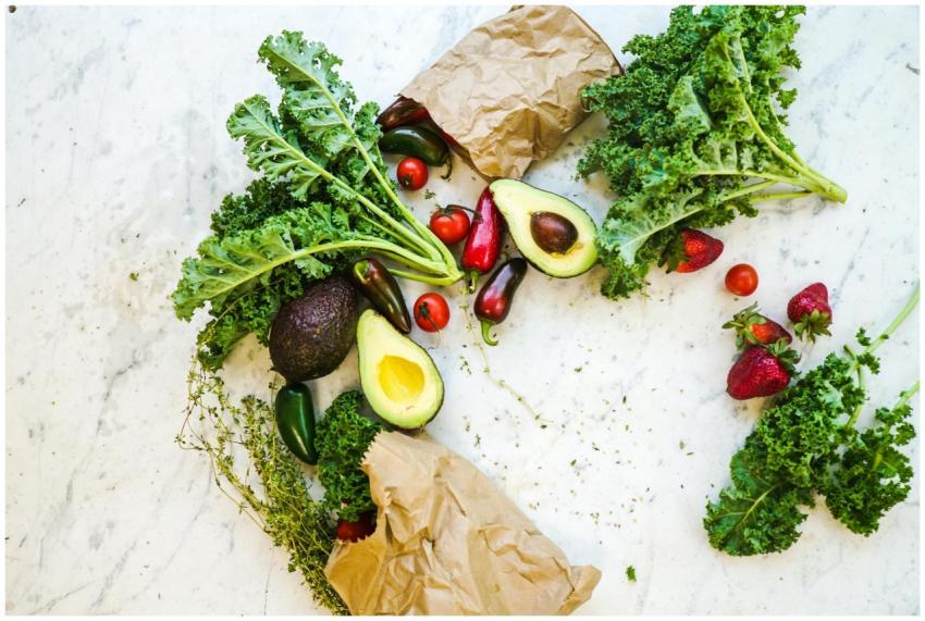 Avocado, kale, and more fresh produce artfully arr