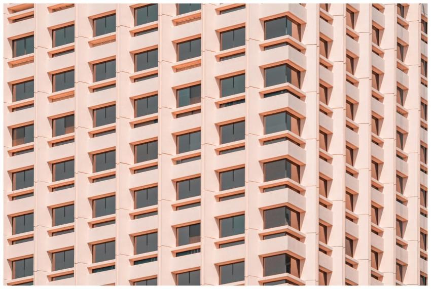 Low angle view of a modern pink building facade in