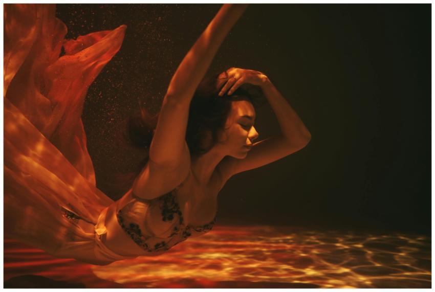 Artistic underwater image of a woman in flowing at