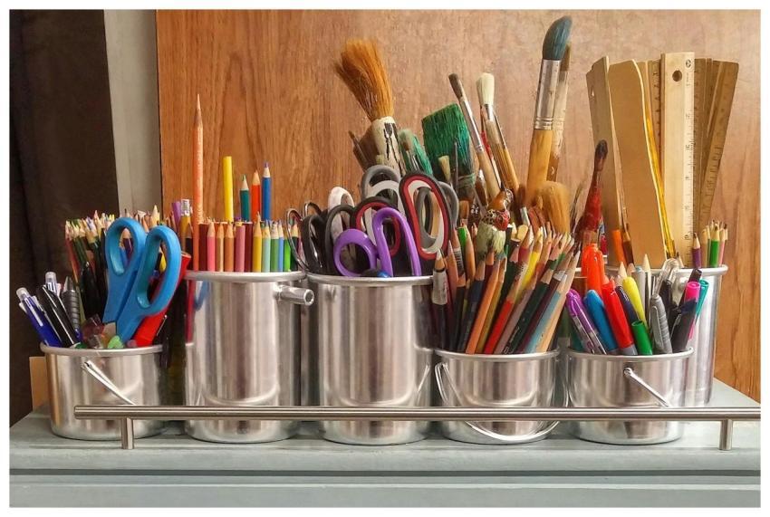 A diverse collection of art supplies in metallic b