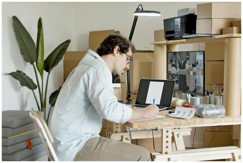 Businessman managing an online store in a home off