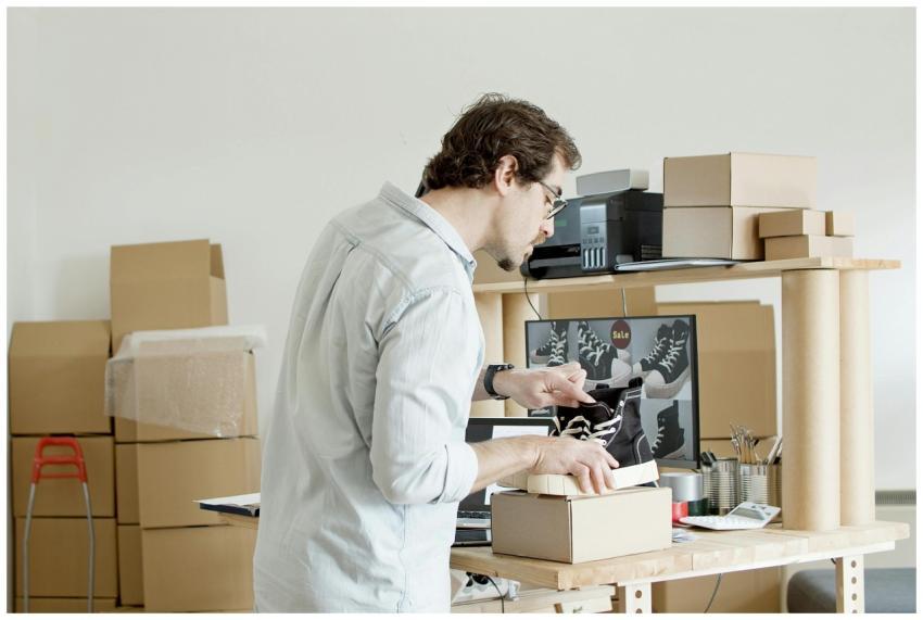 A businessman working in an online store packing s