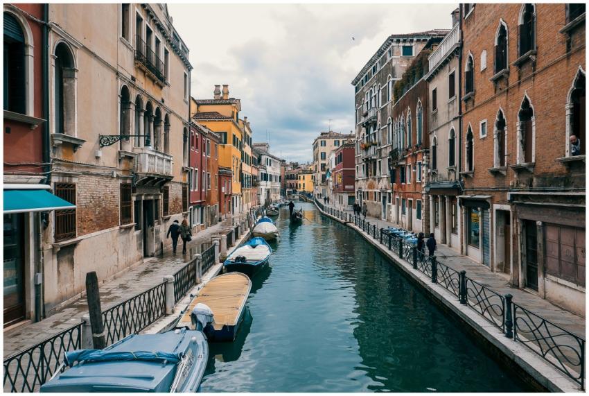 Scenic view of a Venetian canal lined with colorfu