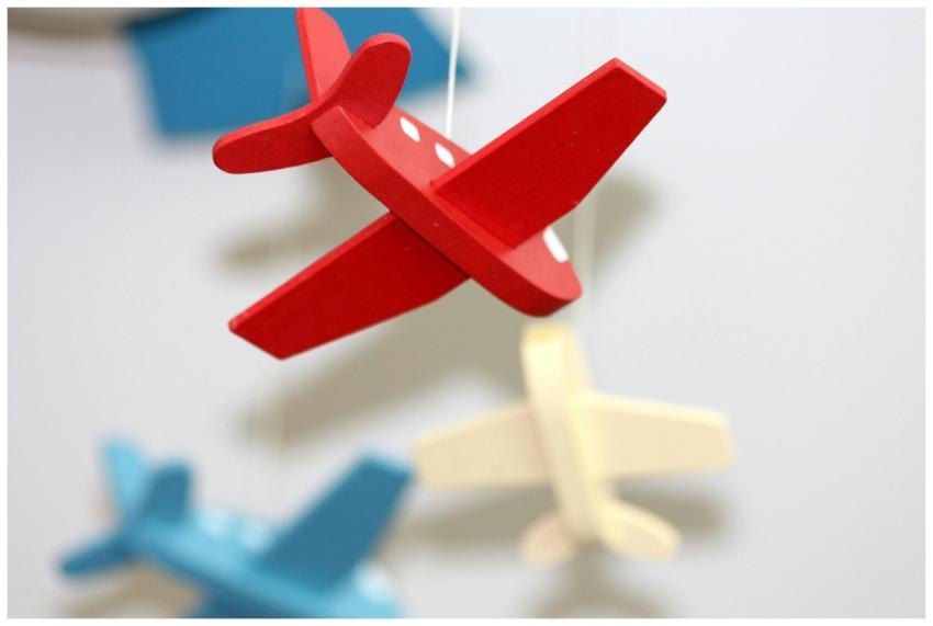 A close-up of colorful wooden airplane toys in a m