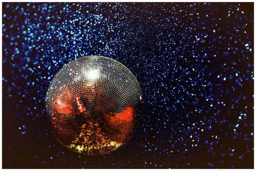 Shining disco ball with colorful reflections in a