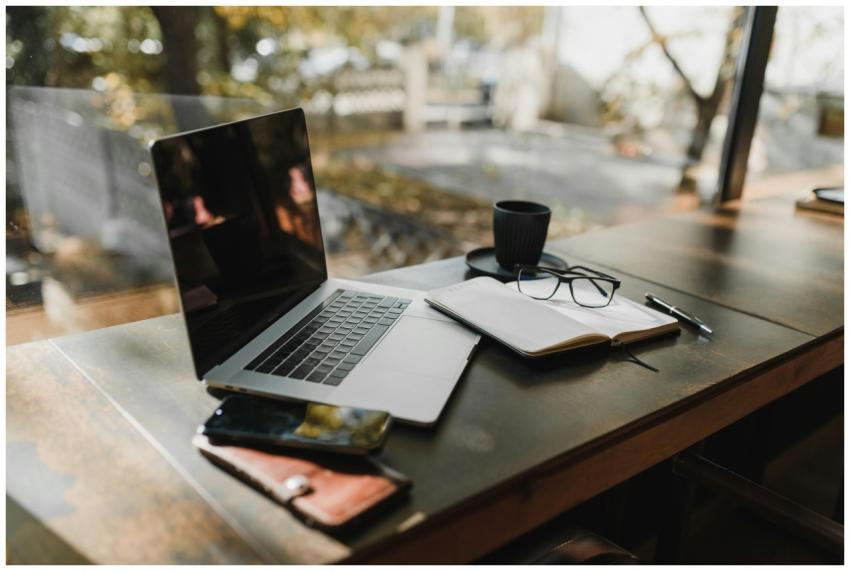 A serene office setup with a laptop, notebook, and