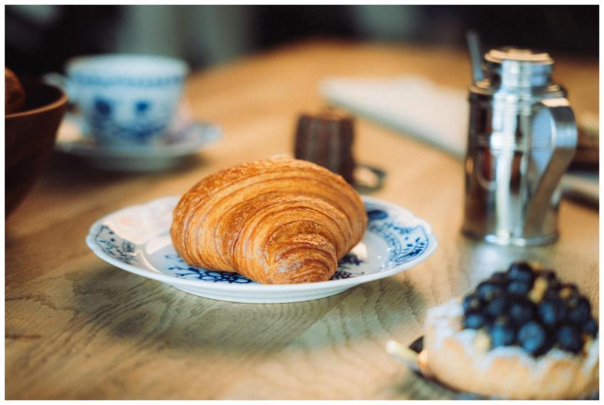 Close-up of a croissant on a patterned plate, acco