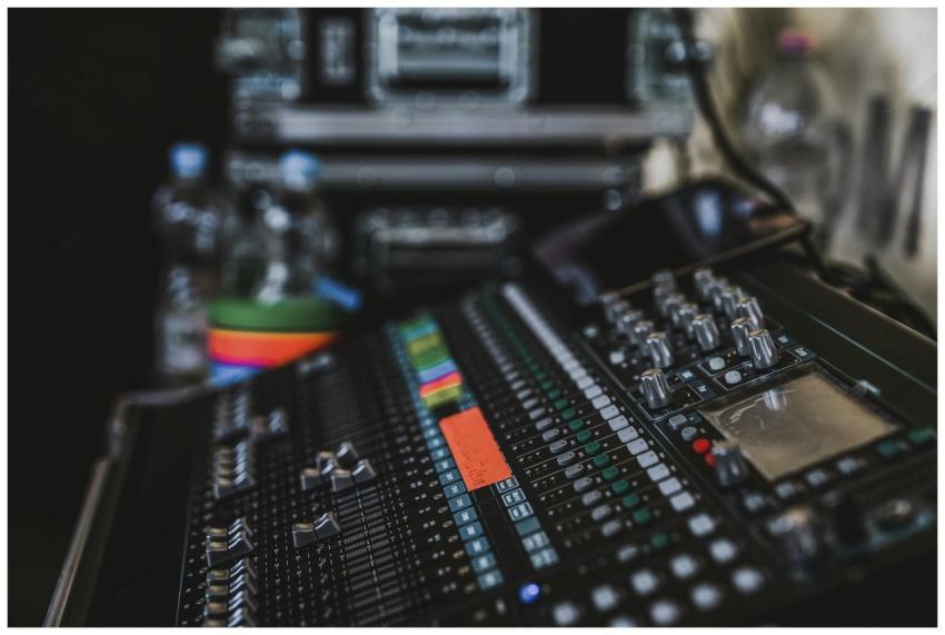 Close-up of a professional audio mixer with variou