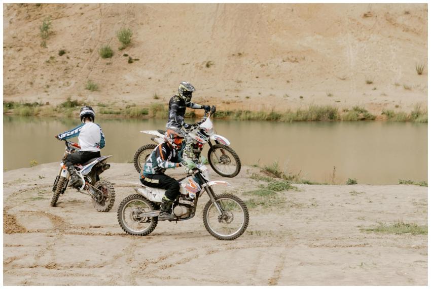 Three motocross riders enjoying an exciting off-ro