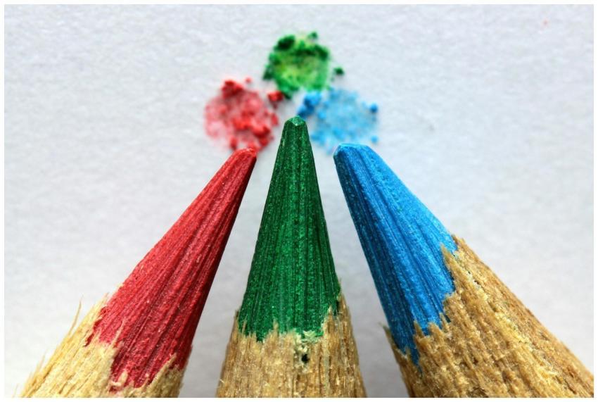 Close-up of red, green, and blue colored pencils w