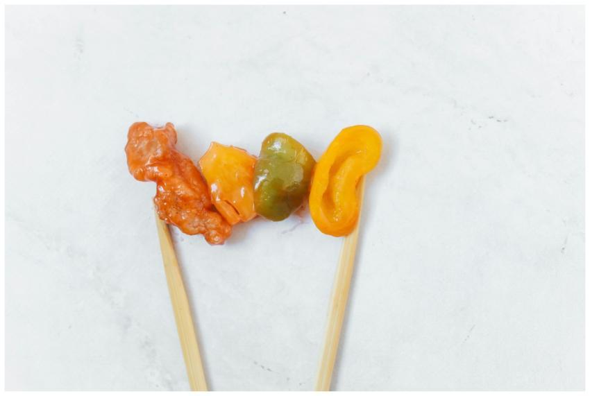 Vibrant skewer of Asian food with vegetables and c