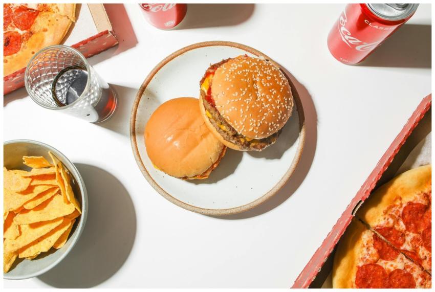 Top view of fast food spread with pizza, burgers,