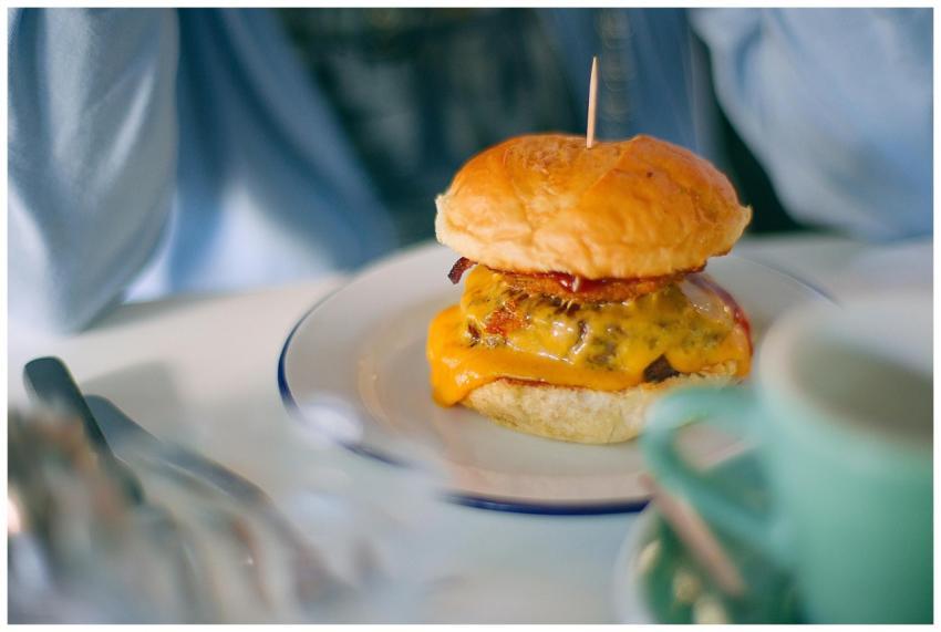 Appetizing cheeseburger with melted cheese served