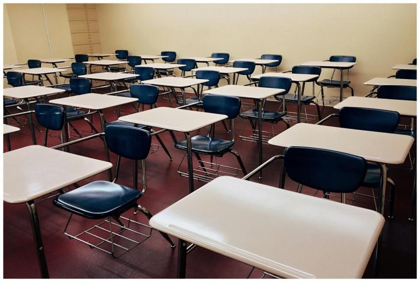 An empty classroom featuring neatly arranged desks